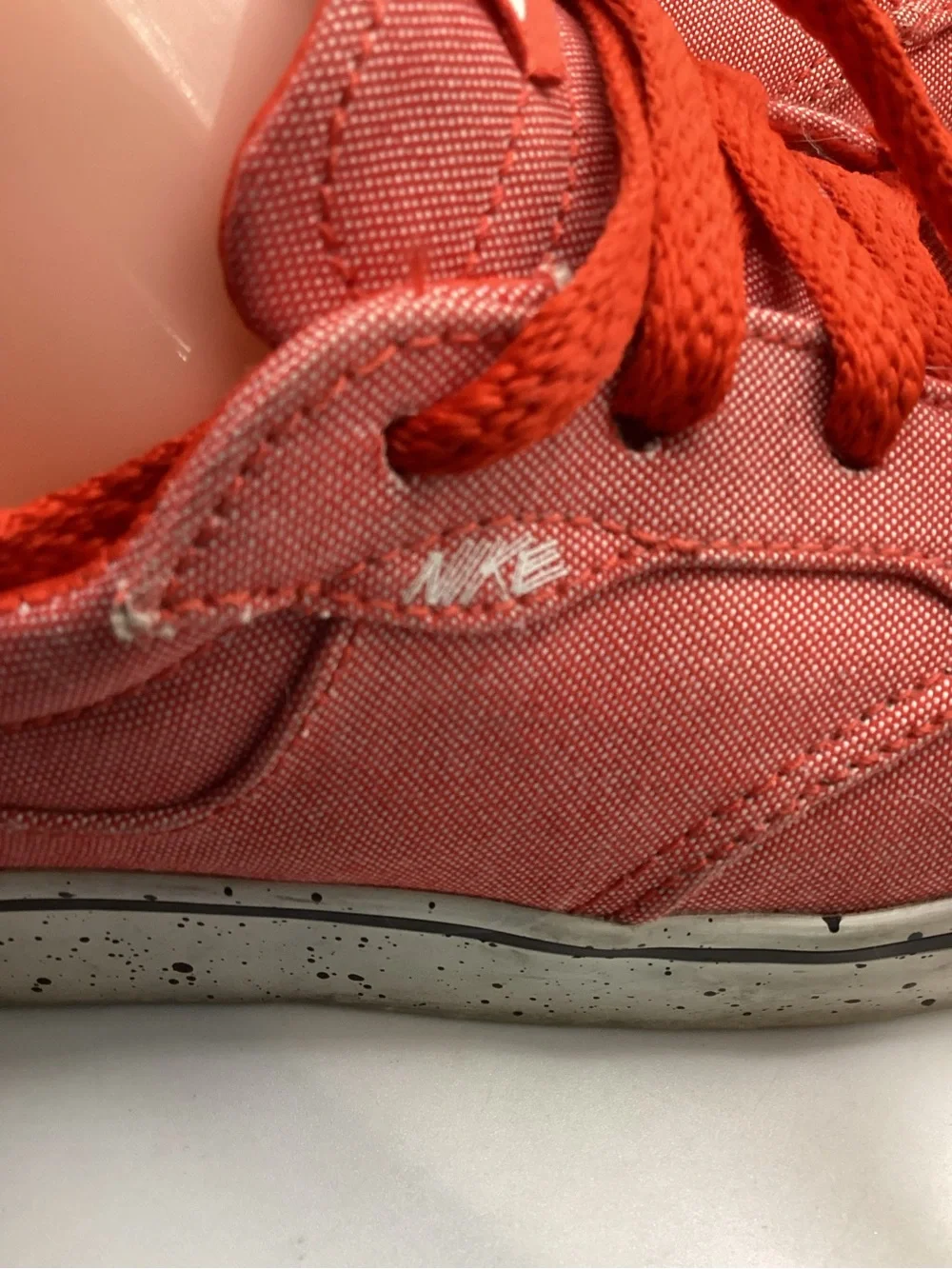 Nike 6.0 skate shoes featuring a vibrant red canvas upper and a speckled midsole